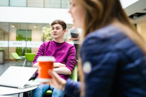 Students chatting with a cup of coffee